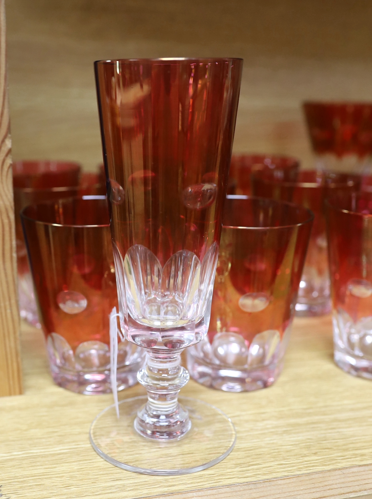 A quantity of cranberry flashed glasses including a set of five, the largest 18cm high